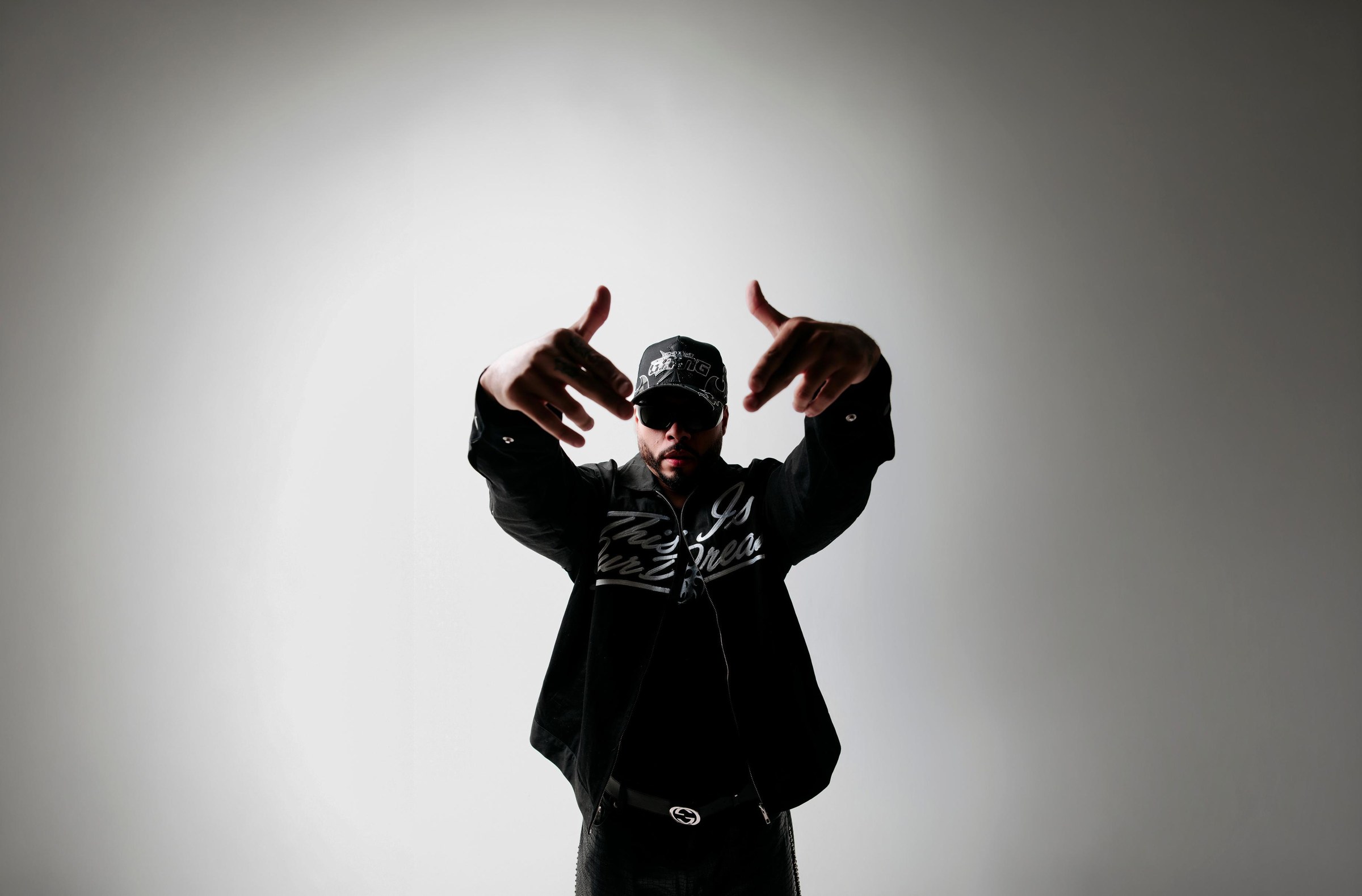 Dynamiqo facing the camera with hands raised